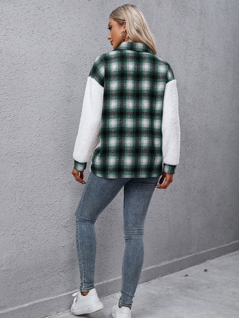 Green plaid shacket with white shearling sleeves and collared neck.