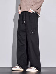 Black loose-fit men's sweatpants with drawstring and utility pocket detail.