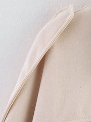 Oversized zip-up jacket in off-white with a textured knit fabric and folded collar detail.
