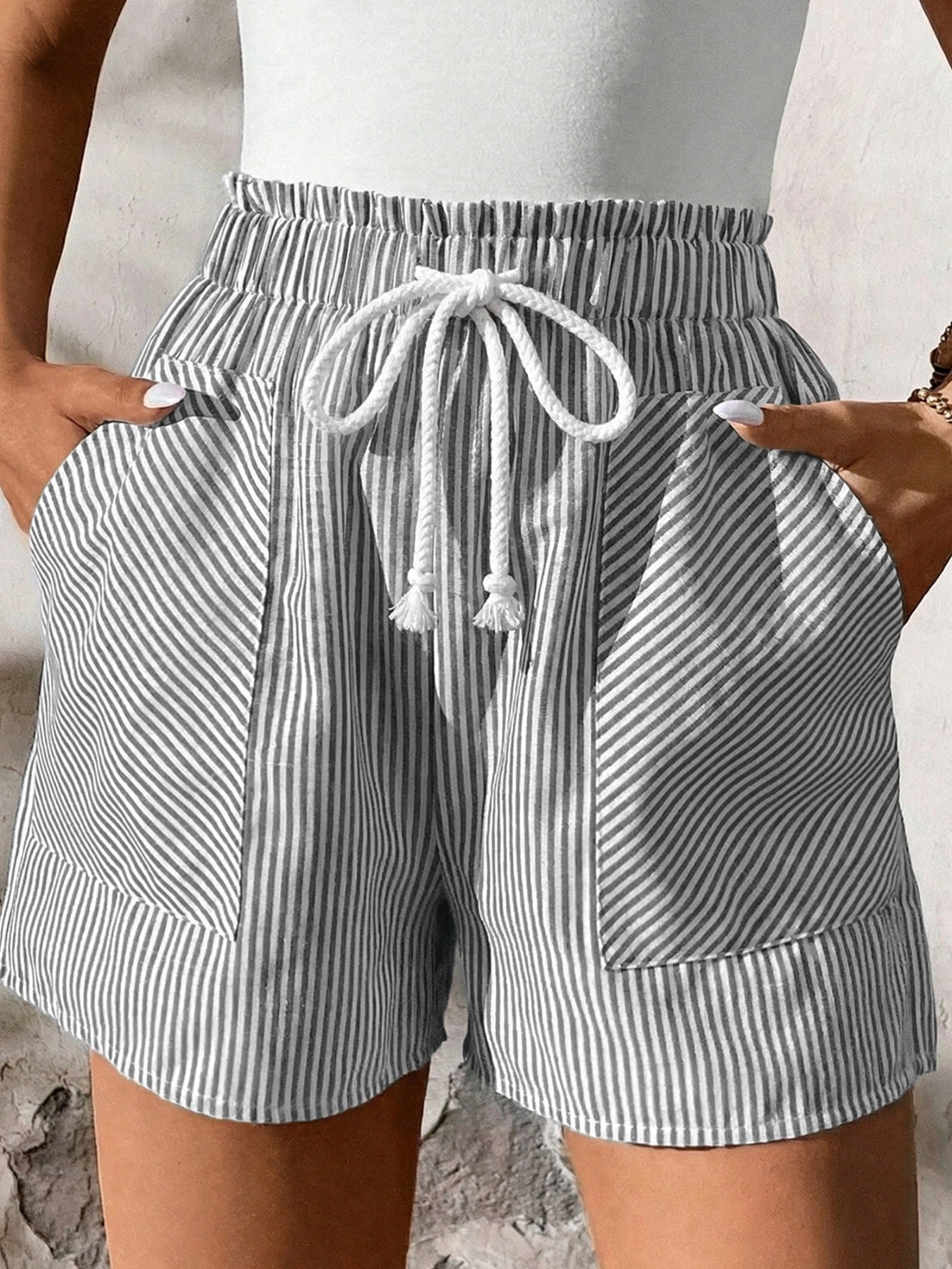 Striped cotton shorts with elastic waist, drawstring, and pockets.