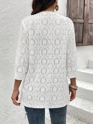 White floral lace duster with 3/4 sleeves and beaded neckline detail.