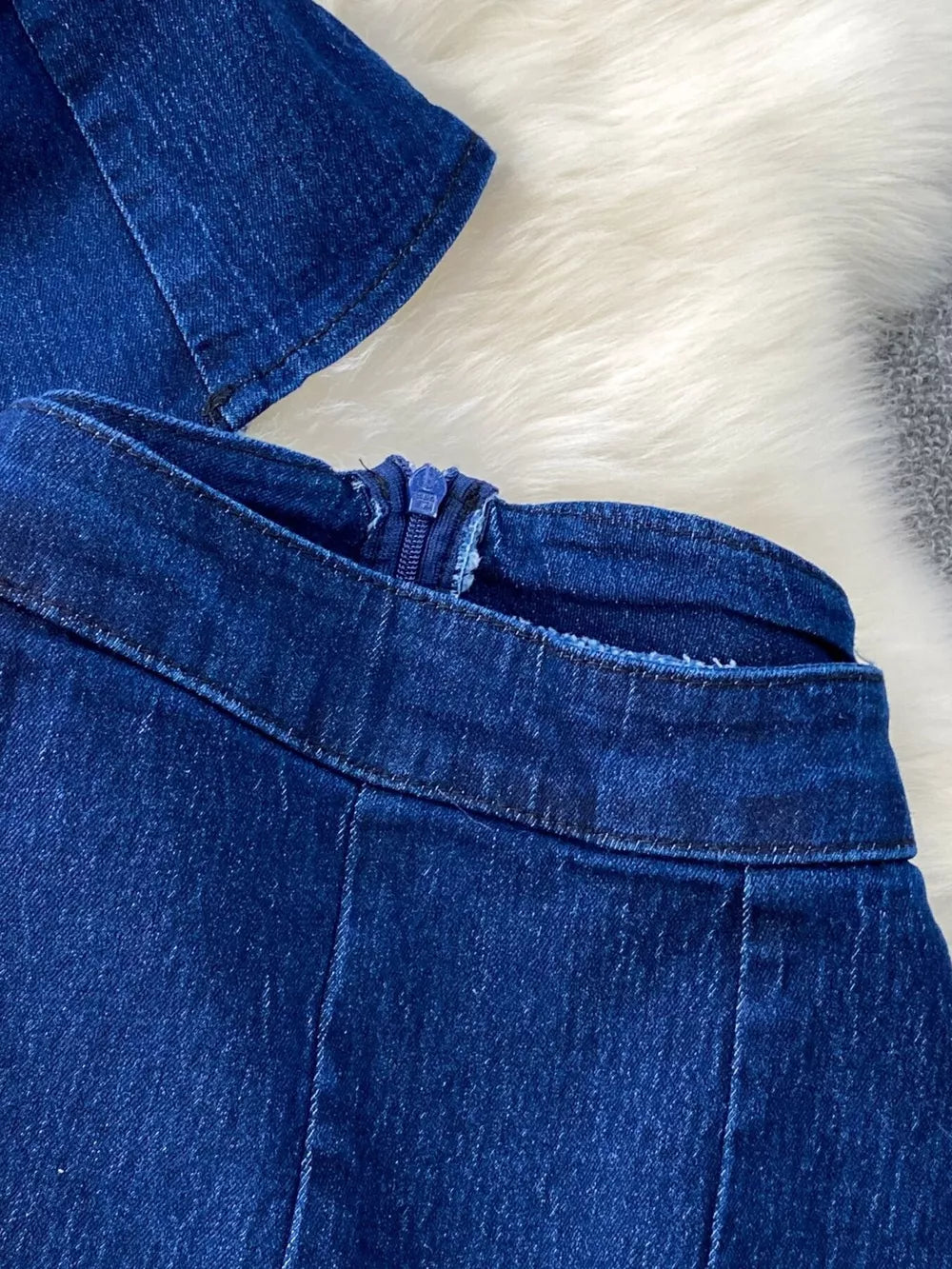 Dark blue cotton denim vest and flare jeans set with zipper detail.