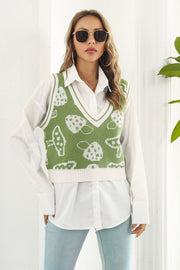 Matcha green knit vest with white mushroom motif and cream trim, V-neck, sleeveless.