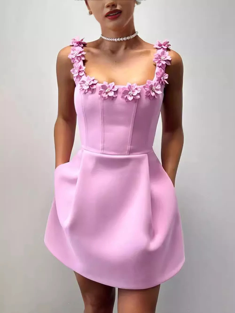 Pink floral embellished mini dress with pockets and square neckline.