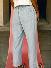 Mid rise drawstring jeans in light blue with white pinstripes and back pockets.