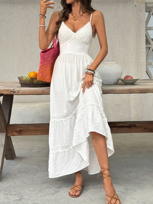 White lace tiered maxi dress with spaghetti straps and scalloped neckline.