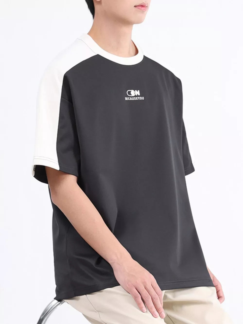 Men's contrast stitch t-shirt in dark gray with white raglan sleeves and chest logo.