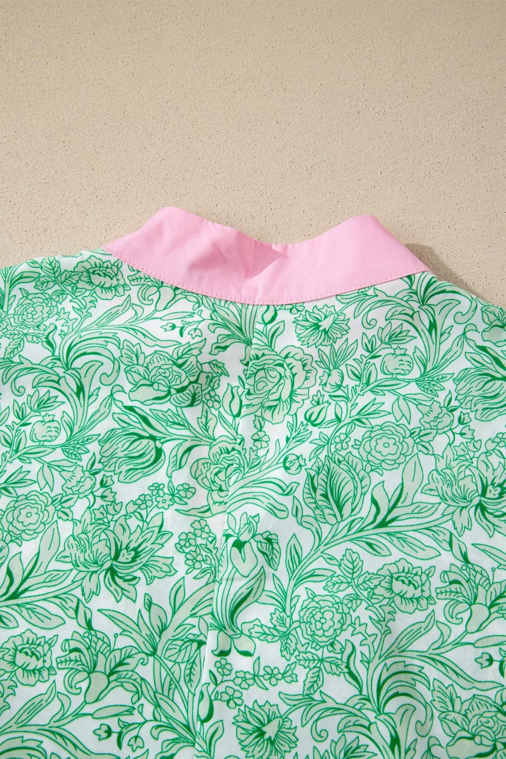 Botanical print midi dress with pink collar and flutter sleeves.
