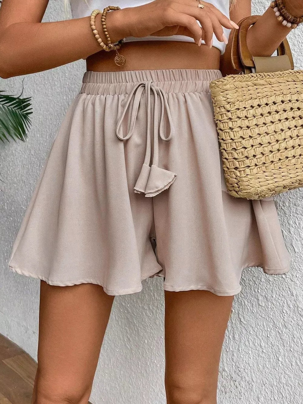 Off white cotton chino shorts with drawstring waist and a-line cut.
