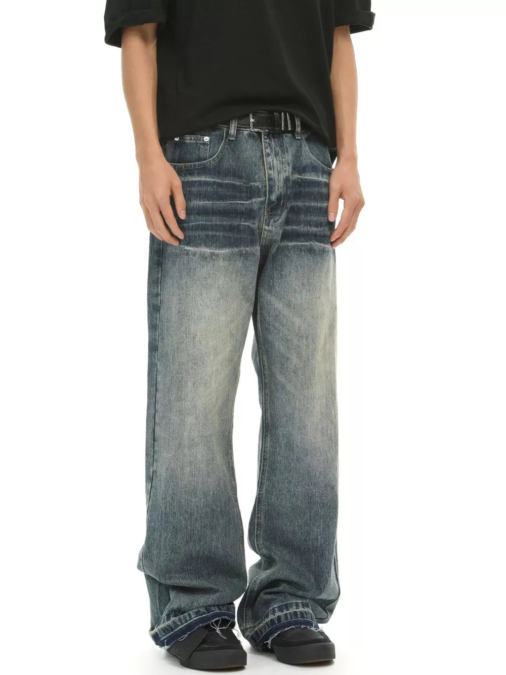 Men's loose fit vintage wash blue cotton jeans with distressed detailing.