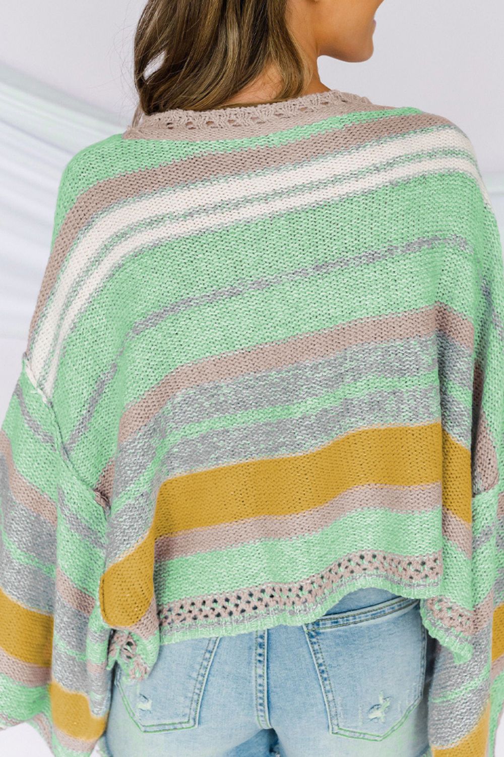 Open-shoulder knit pullover with horizontal stripes in gum leaf, featuring a boatneck and distressed hem.