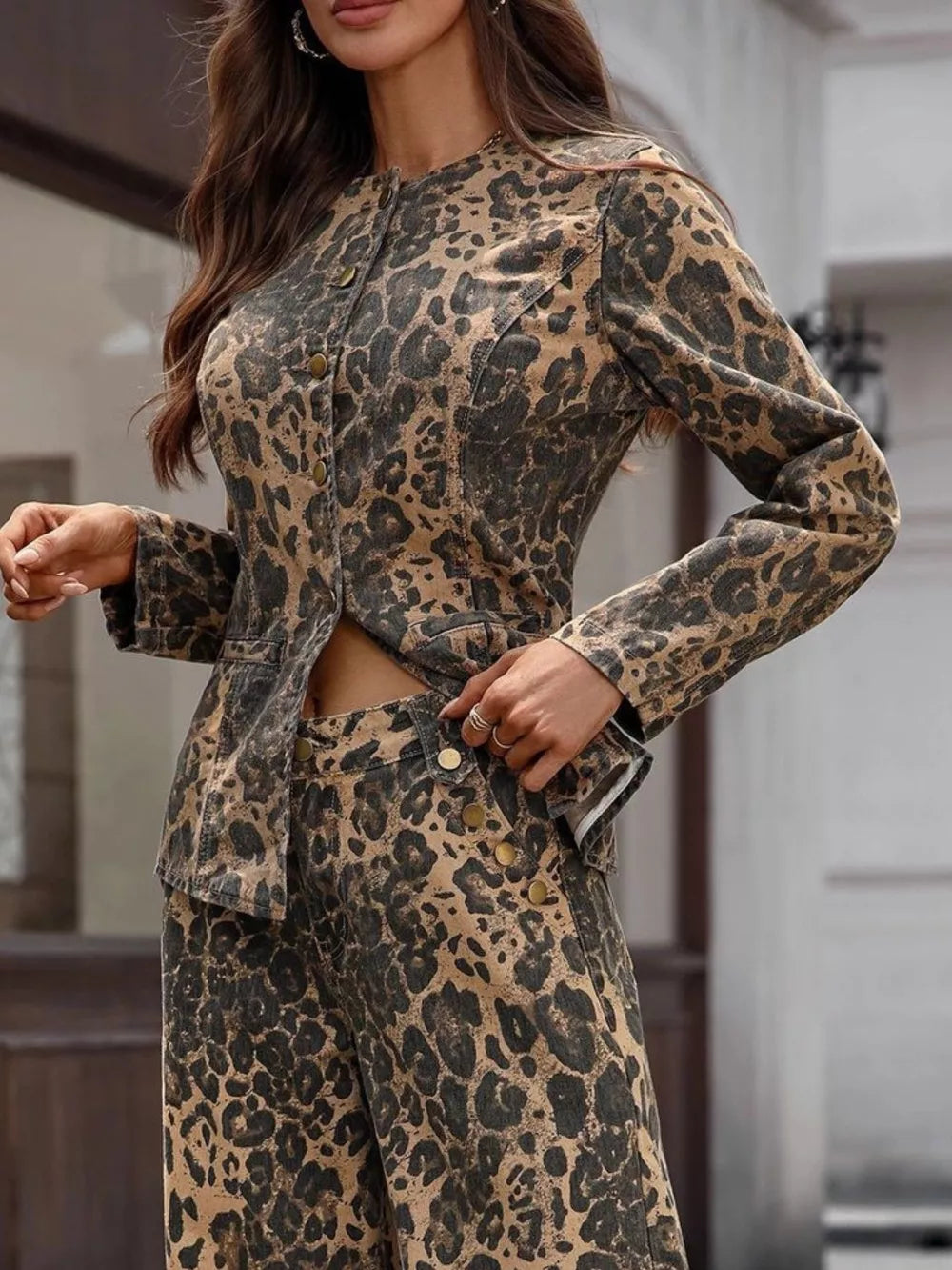 Sleek leopard print denim bolero jacket with button-up front and collarless neckline.