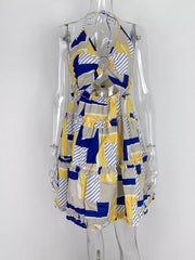 Abstract print halter mini dress with cutout detail and tiered ruffle skirt.