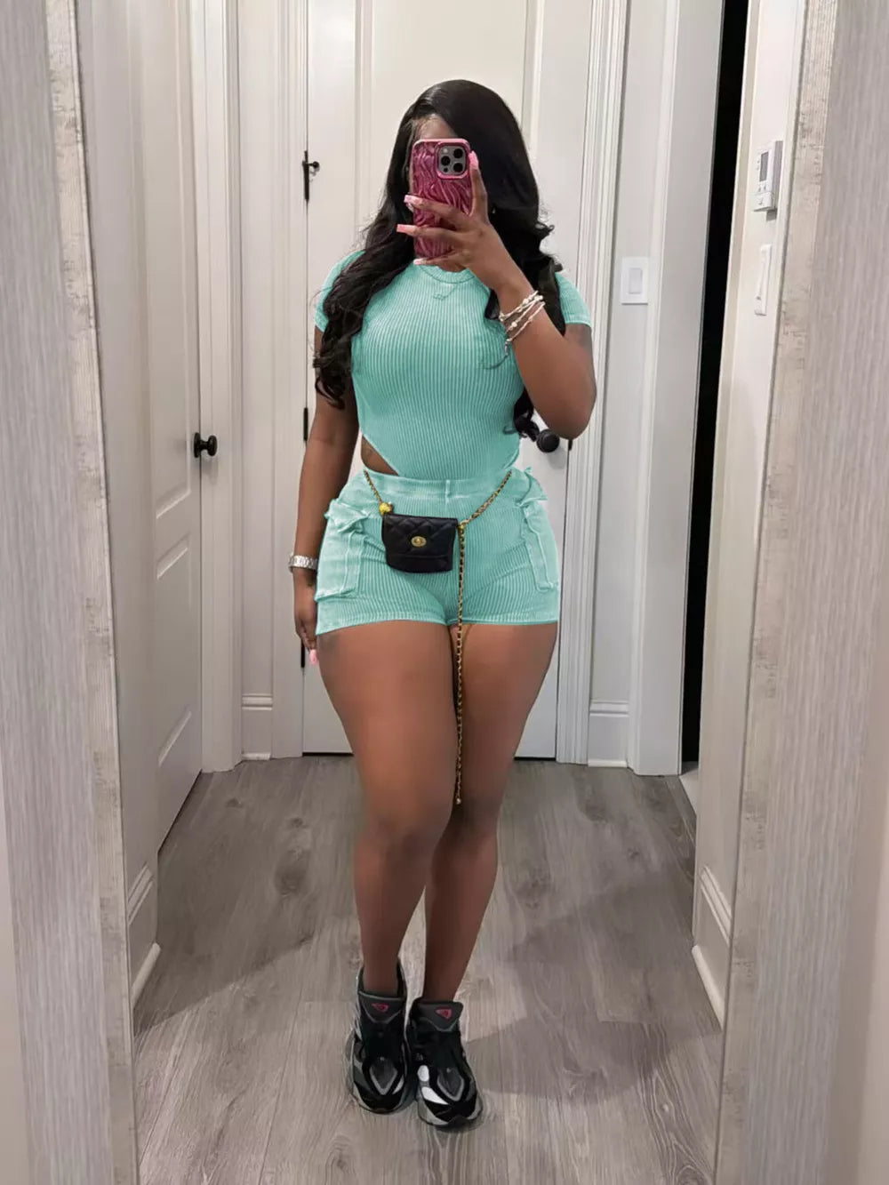 Sky blue ribbed crop top and pocket shorts set with a gold chain belt.