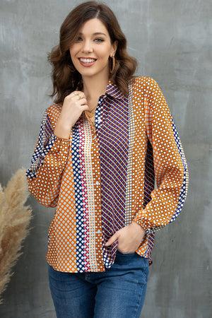 Geometric print blouson sleeve blouse in orange, blue, and purple with a buttoned front.
