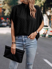 Black textured dot back-tie blouse with short sleeves and mock neck.