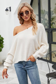 Off-shoulder ribbed knit sweater in white with balloon sleeves and boat neckline.