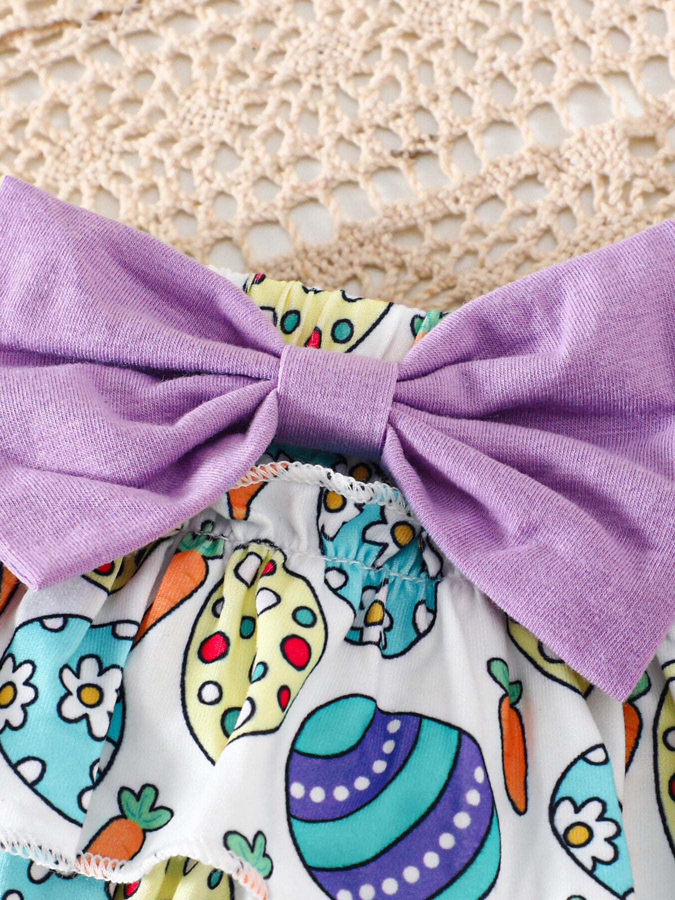 Easter graphic bodysuit and skirt set with purple bow and egg print.
