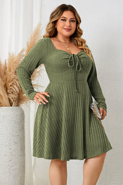 Matcha green ribbed fit-and-flare midi dress with tie-front neckline and long sleeves.