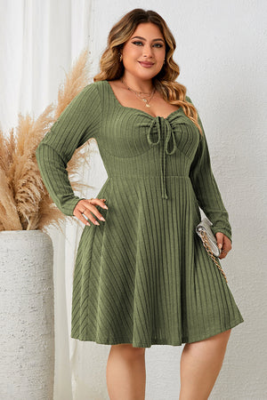 Matcha green ribbed fit-and-flare midi dress with tie-front neckline and long sleeves.