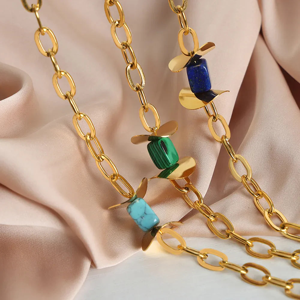 Geometric malachite pendant necklace with 18K gold-plated chain and blue, dark green, and light blue stones.