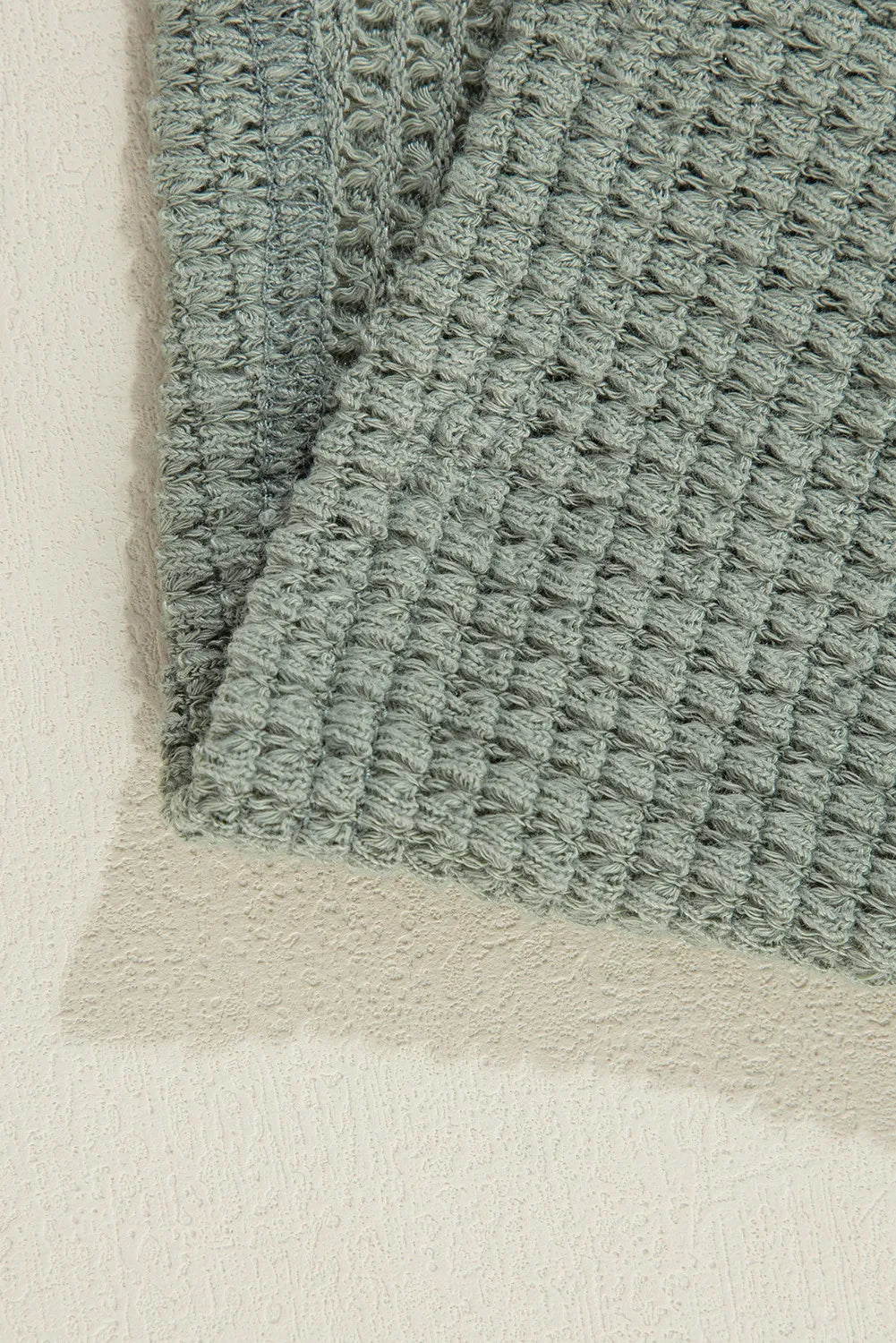 Sage waffle knit open-front duster cardigan with textured fabric detail.