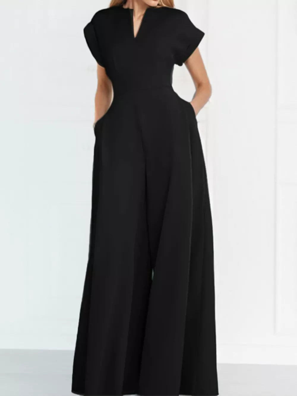 Black wide-leg romper with V-neck, short sleeves, and pockets.