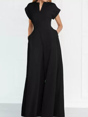 Black wide-leg romper with V-neck, short sleeves, and pockets.
