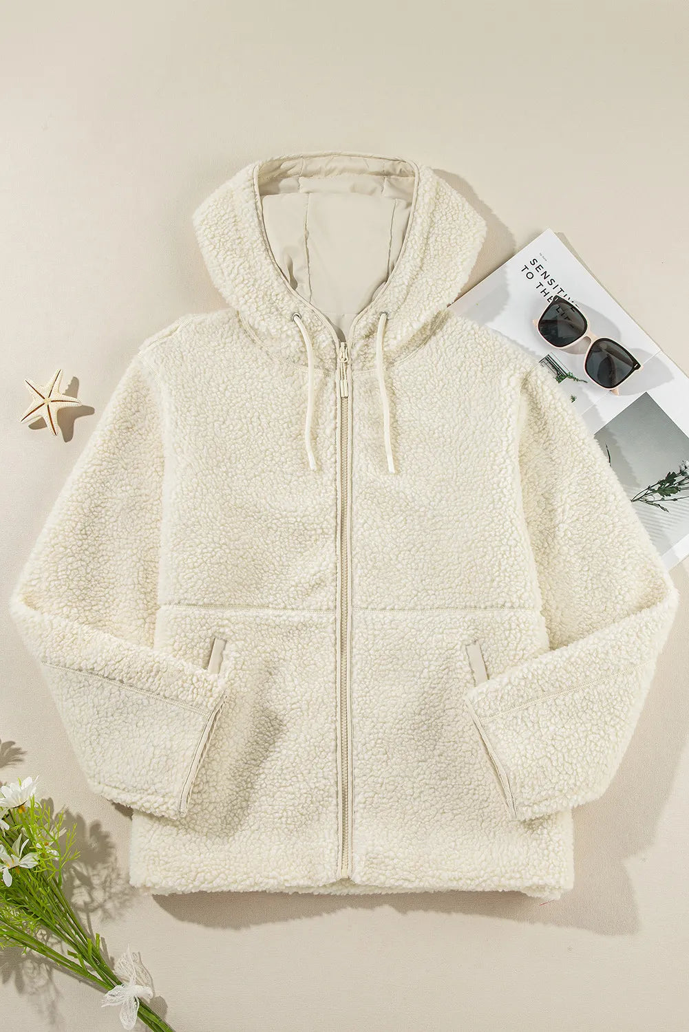 Textured fleece zip-up hoodie in ivory with a drawstring hood and front pockets.