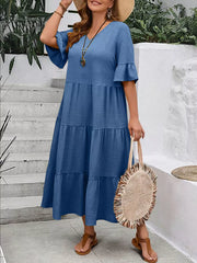 Navy blue crinkled midi dress with ruffle sleeves and tiered skirt.