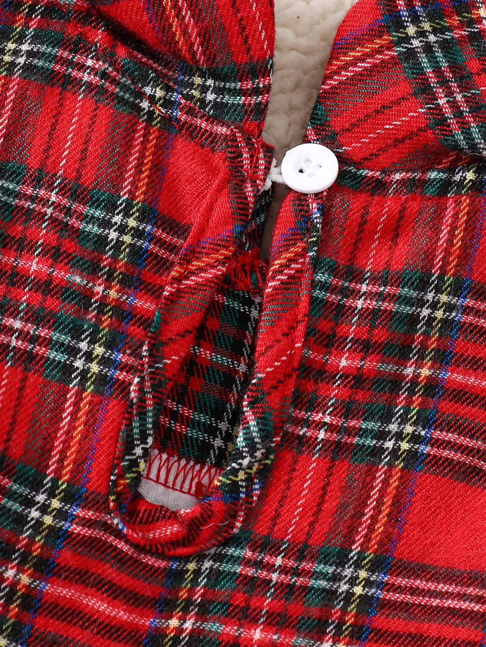 Red plaid baby dress with white button detail and cotton blend fabric.