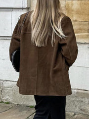Brown suede blazer with structured shoulders and button detail.