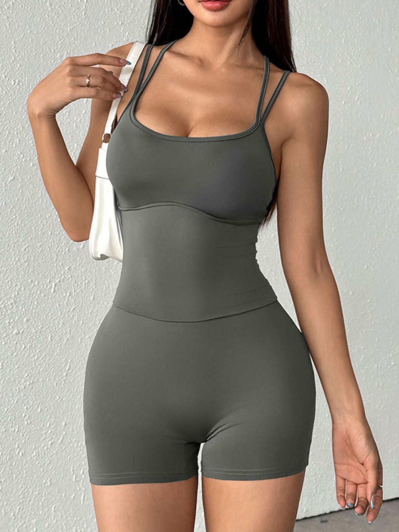 Grey scoop neck active romper with double spaghetti straps and bodycon fit.