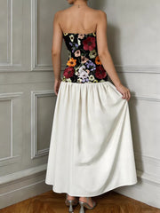 Maxi dress with embroidered floral bodice and white skirt.