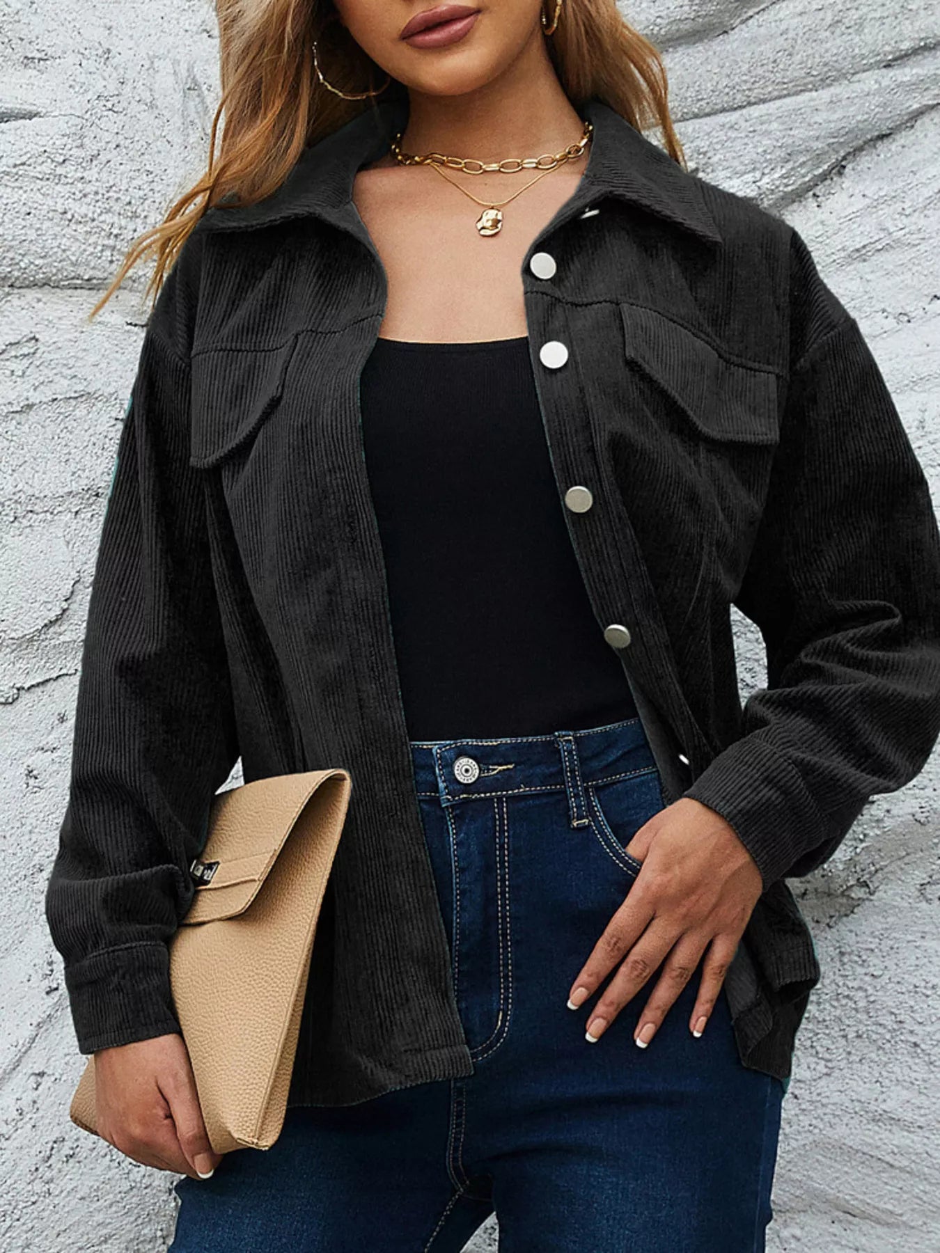 Black corduroy button-up jacket with chest pockets and silver buttons.