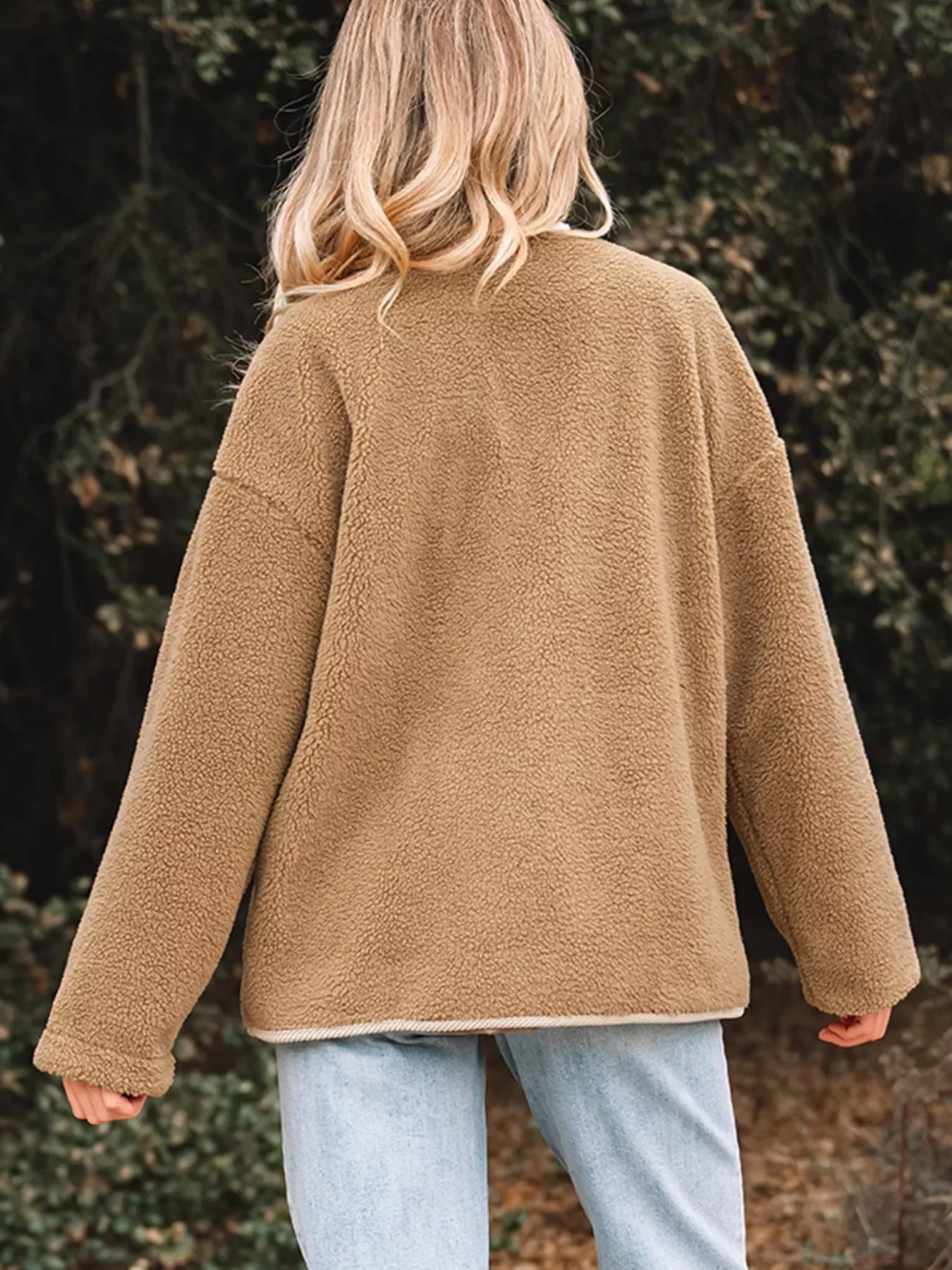 Plush camel teddy jacket with sherpa texture and contrast trim.