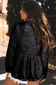 Black gathered sleeve blouse with textured fabric and ruffled hem