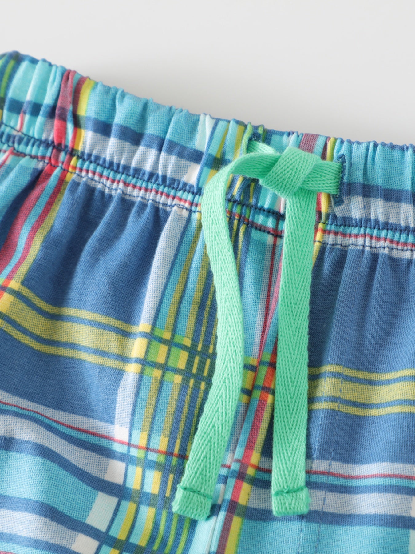 Toddler blue plaid cotton shorts with green drawstring detail