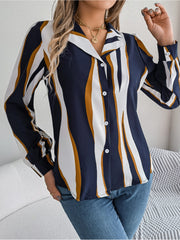 Collared blouse with wavy stripes in dark blue, white, and mustard yellow, featuring button front and long sleeves.