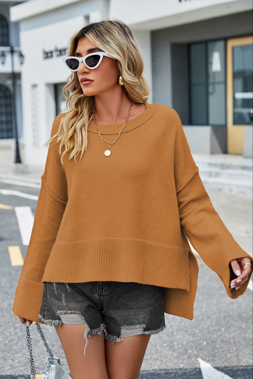 Ochre acrylic knit sweater with flared sleeves and split hem detail.