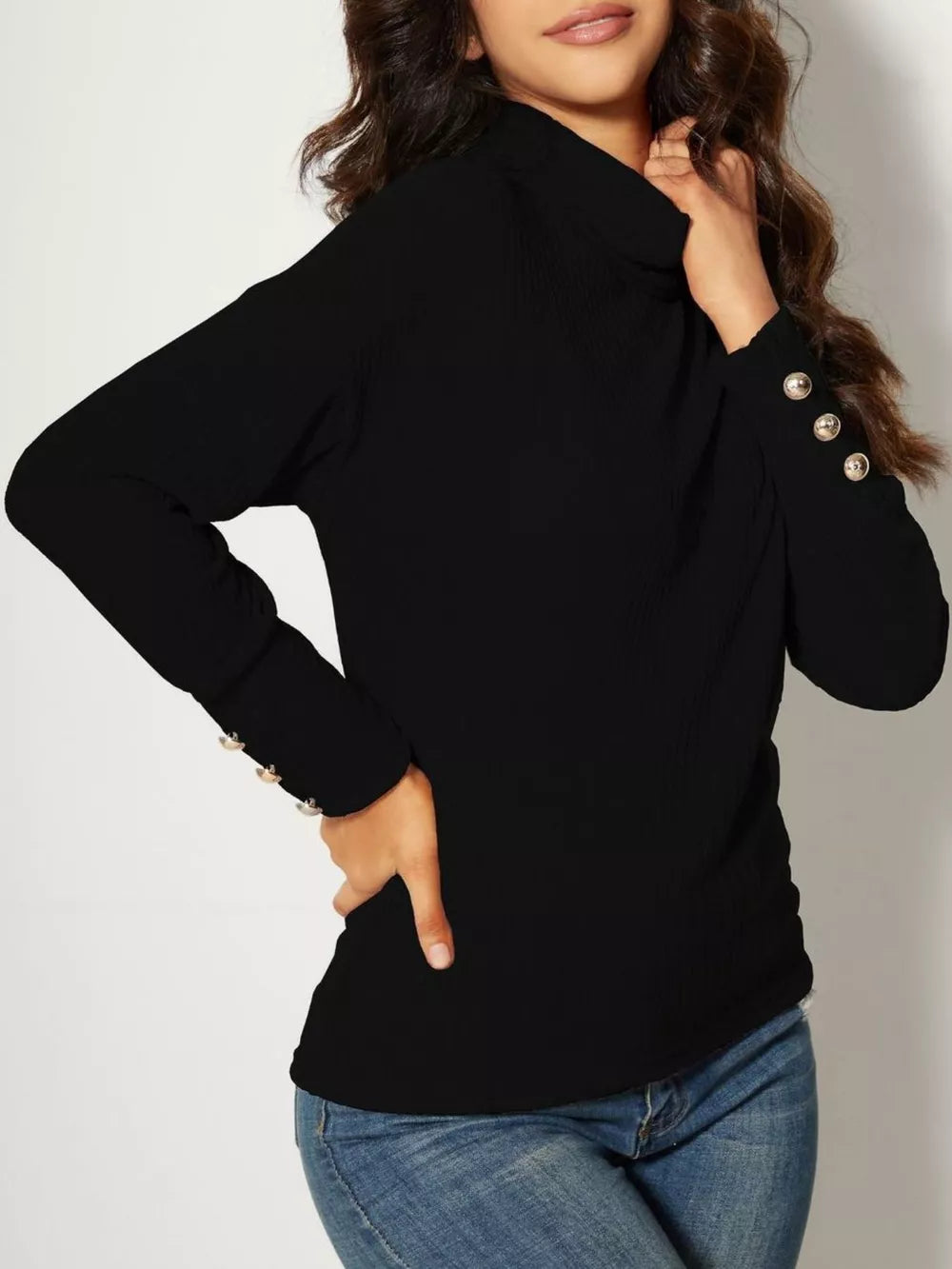 Black ribbed turtleneck knit top with decorative buttons on the cuffs.