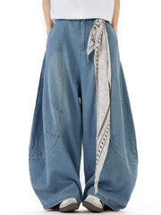Men's wide leg jeans in light wash denim with a patterned tie belt detail.