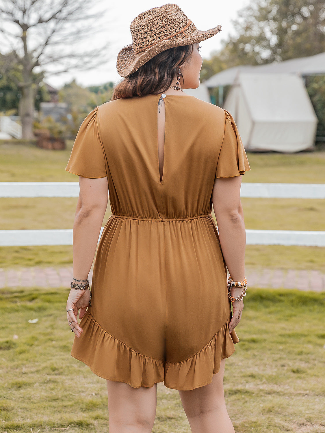 Caramel romper with flutter sleeves, elastic waist, and ruffled hem.