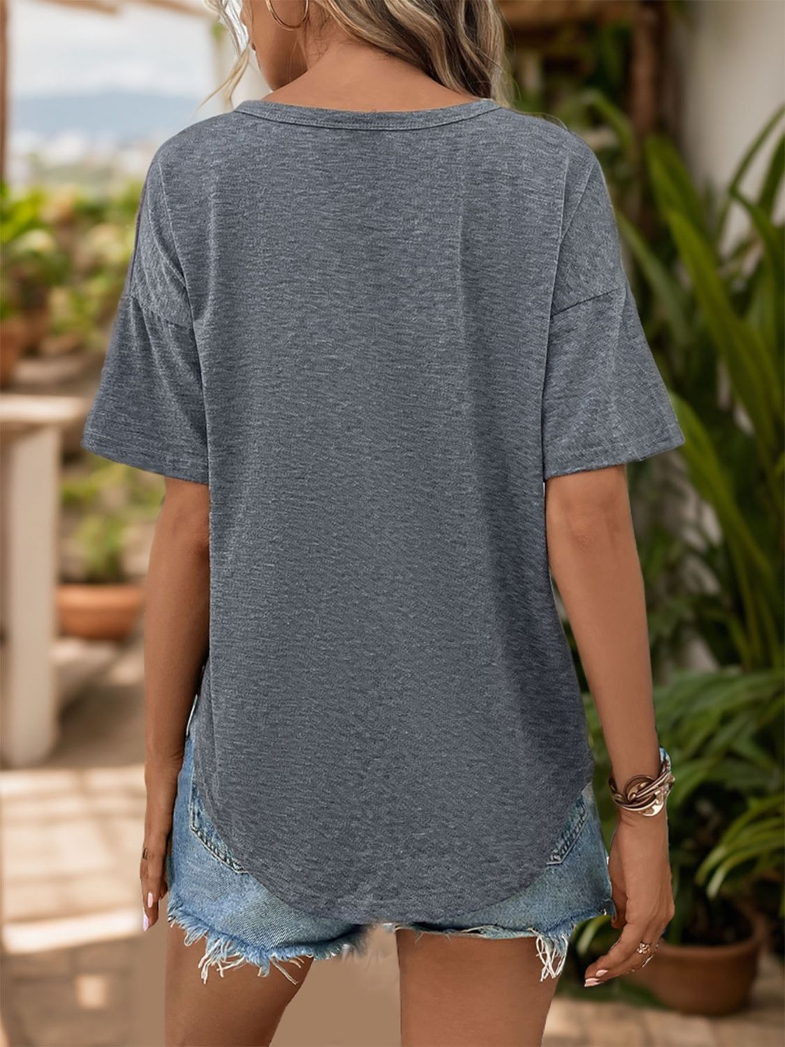 Dark gray button-down henley tee with short sleeves and a knot-front detail.
