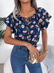 Dark blue floral ruffle sleeve tie-neck blouse with white and tan flowers.