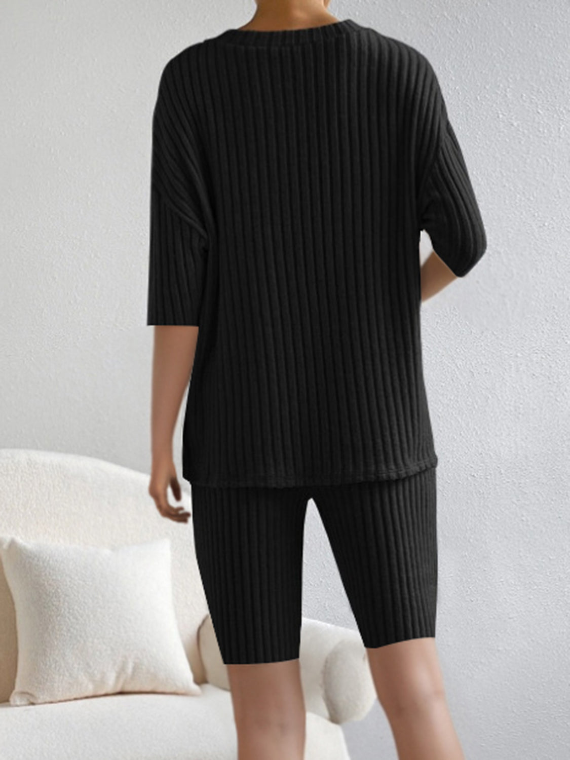 Black ribbed loungewear set with V-neck top and biker shorts.