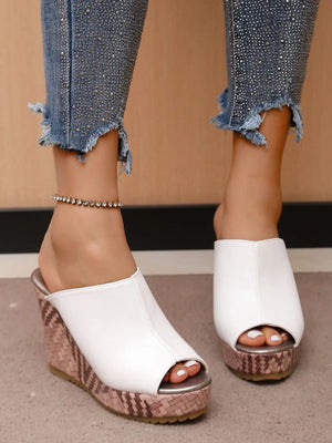 White textured wedge mules with open toe and woven platform.