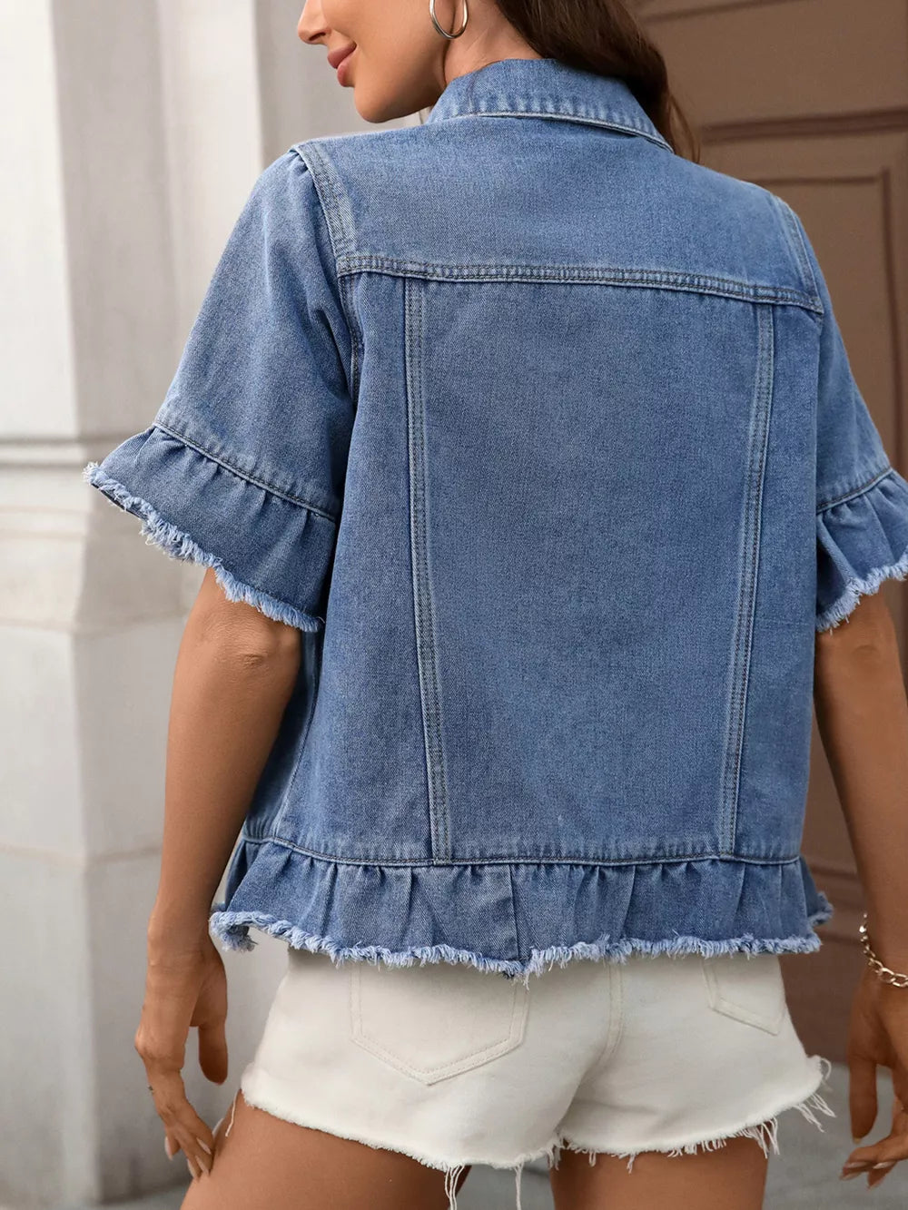 Blue denim trucker jacket with short ruffled sleeves and raw hem
