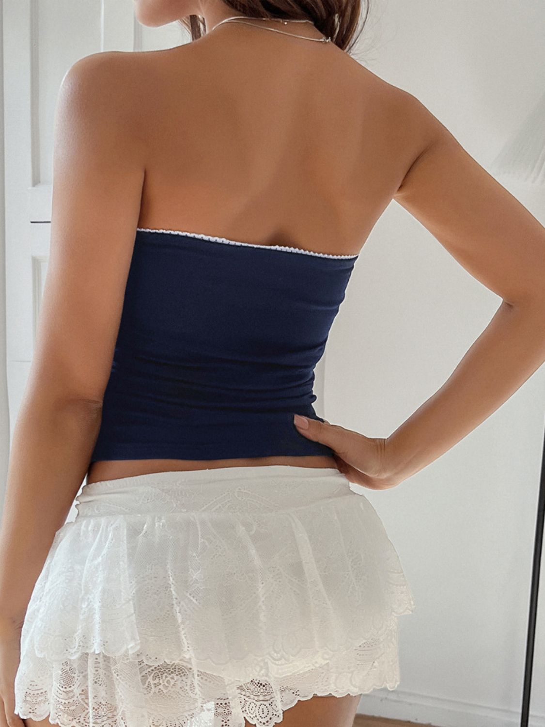 Navy bandeau top with white trim detail.
