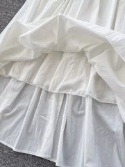 White gathered waist high-waisted skirt with pockets, showing layered fabric detail.